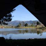 Aussicht auf einen See aus dem Inneren eines Zeltes mit schwarzer Schlafkabine